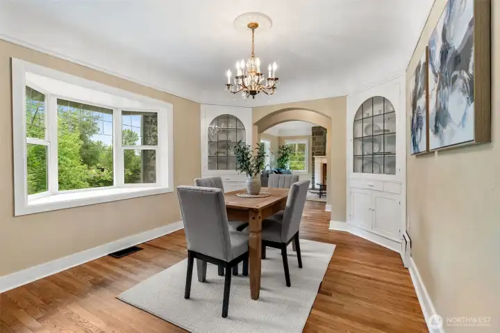 Dining room with beautiful chandelier and built in glass cabinets. Dining room with beautiful chandelier and built in glass cabinets.
