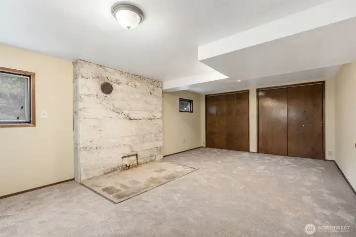 Basement level living room with large closets. Basement level living room with large closets.