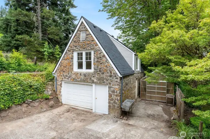 Detached garage with cottage above and greenhouse on the side. Detached garage with cottage above and greenhouse on the side.