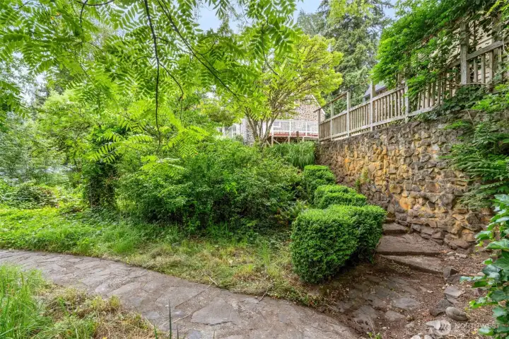 Stairs along greenhouse wall that lead to bridge, orchard, shop and creek. Stairs along greenhouse wall that lead to bridge, orchard, shop and creek.