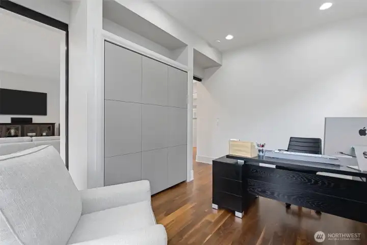 Built in Murphy Bed pulls down to create bedroom on main floor, served by walk-in shower and powder room on the main living floor ( 2-story).
