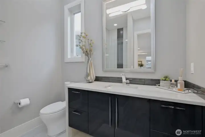 Powder room + walk in shower on 2nd (main) floor living.