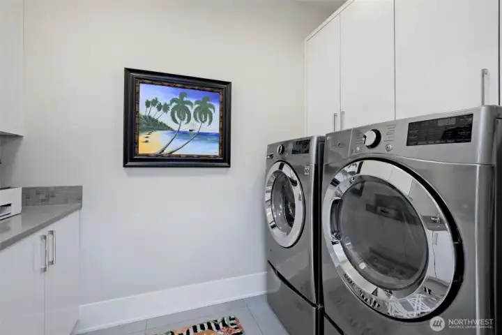 Laundry room up top floor w additional cabinets and counter space.