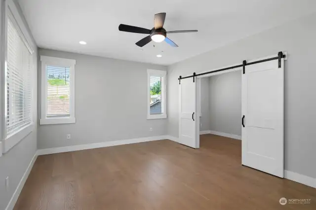The expansive Primary Bedroom makes a statement with gorgeous barn doors leading to an owner’s retreat with coffee bar!