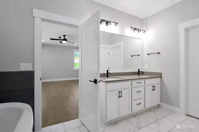 Enjoy the possibilities with an over-sized walk-in closet, glass-enclosed shower, and double-sink vanity in the primary bathroom