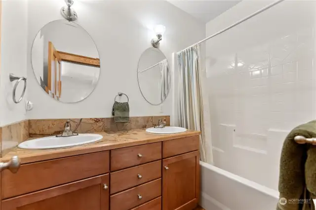 Ensuite Bath has double sinks, tiled counter. Cherry wood cabinets. Linen storage.