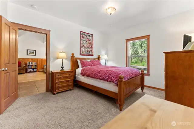 Primary bedroom located on main level of Bear Paw cabin. Carpeted and enjoys ensuite bath.