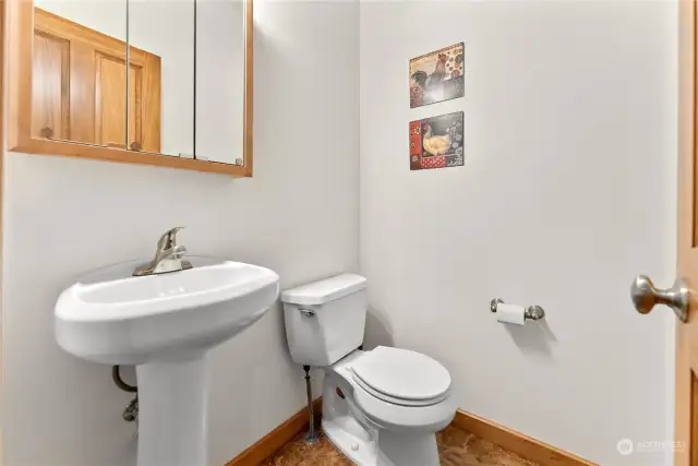 1/2 Bath main level of cabin. Tiled floor Pedestal sink. Toilet.