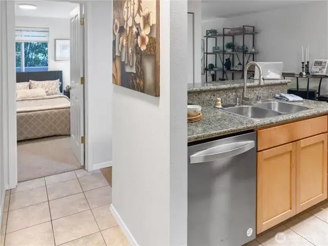 8. Welcome home, and come on in! The bathroom is to the left, the bedroom is straight ahead, and if you take a right, you'll find the kitchen, the eat-in bar, the dining room, the living room, and a pair of closets - one of which has a stackable washer and dryer and a new water heater.