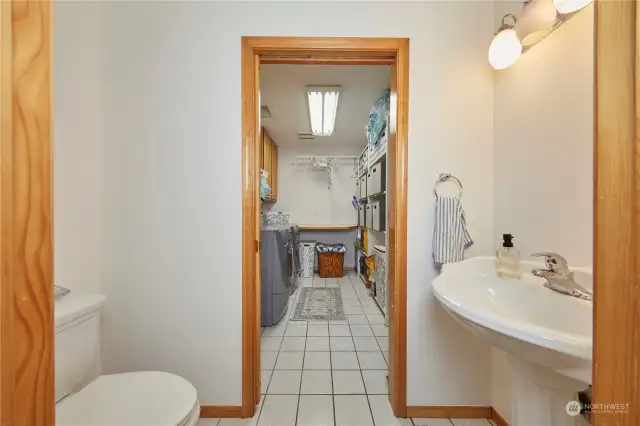 Massive laundry room with an attached powder room.