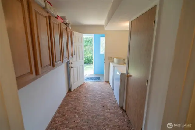 Laundry room with door outside.