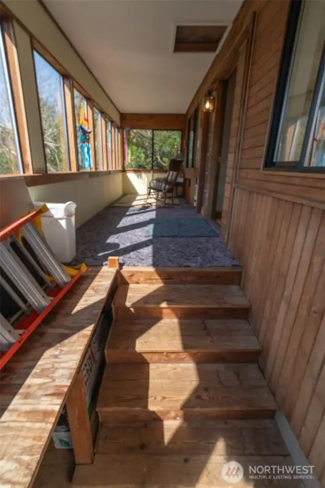 Steps inside the front door to the main home, leading to the sun room.