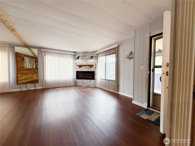 Living Room off of kitchen and entry with heat producing electric fireplace