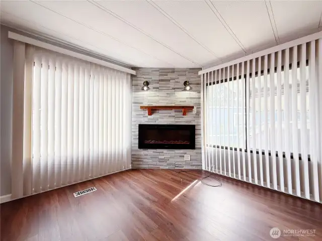 Living Room off of kitchen and entry with heat producing electric fireplace