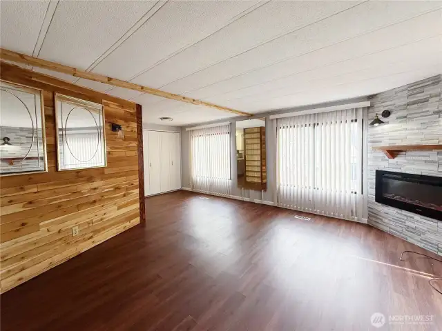 Living Room off of kitchen and entry with heat producing electric fireplace