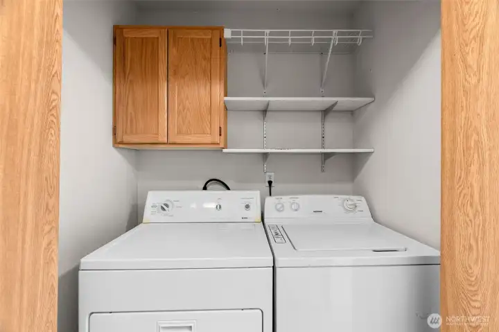 laundry area located in hallway.
