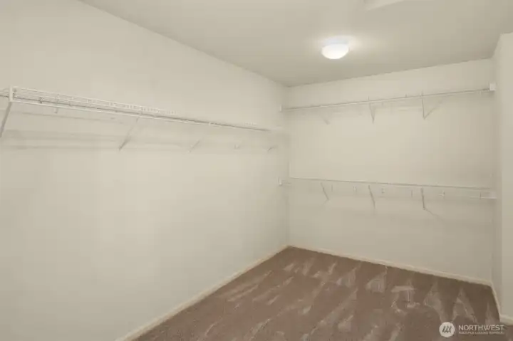 Spacious walk-in closet off primary bathroom.