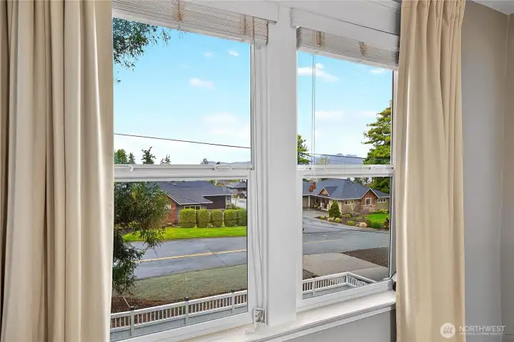 Large window overlooks the side yard and out toward the Guemes Channel.