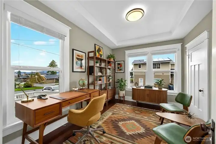 Main level office or den space located just off the living room offers flexibility. In this picture this room is virtually staged, currently being used as a play room.