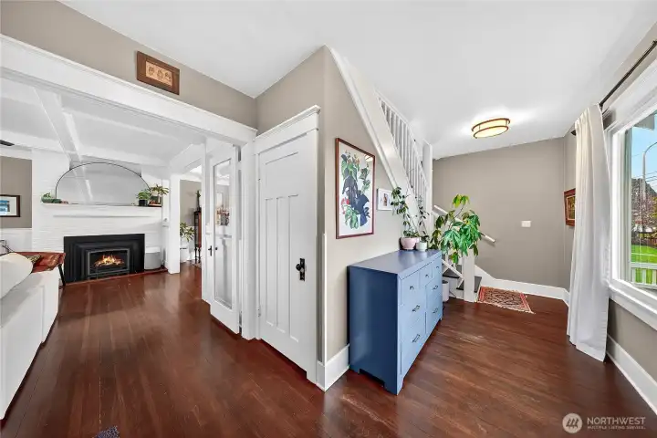 View from the front door looking towards the living and the entry space with double glass French doors.