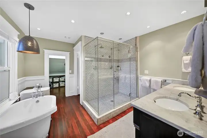 Double vanity, tile shower and traditional clawfoot tub.
