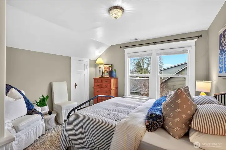 Second bedroom with closet and charming ceiling details.
