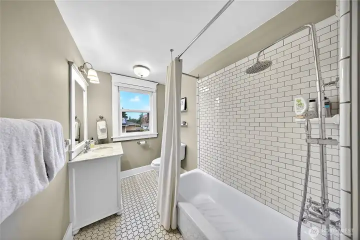 Additional upstairs bathroom with subway and honeycomb tile.