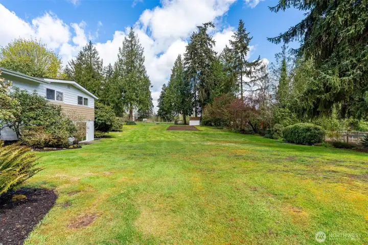 The property features an in-ground sprinkler system and a new backflow system.