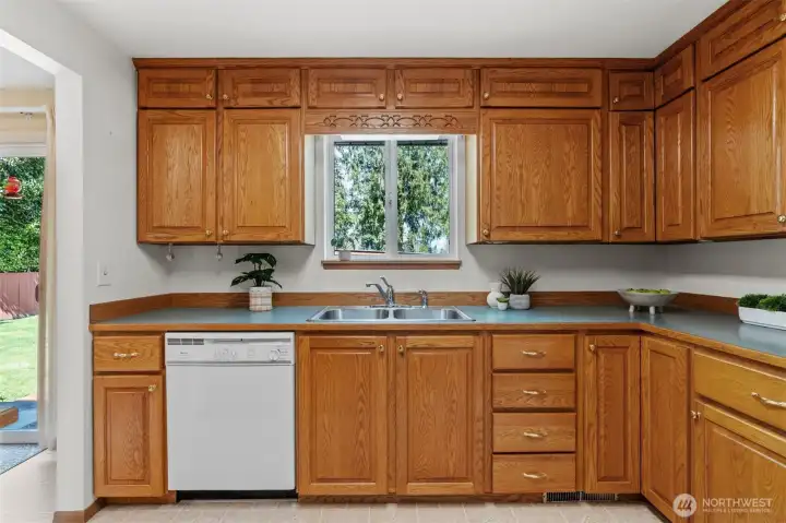 Wow! Look at the amount of storage and counterspace in the kitchen! Enjoy the view of the peaceful yard while washing dishes.
