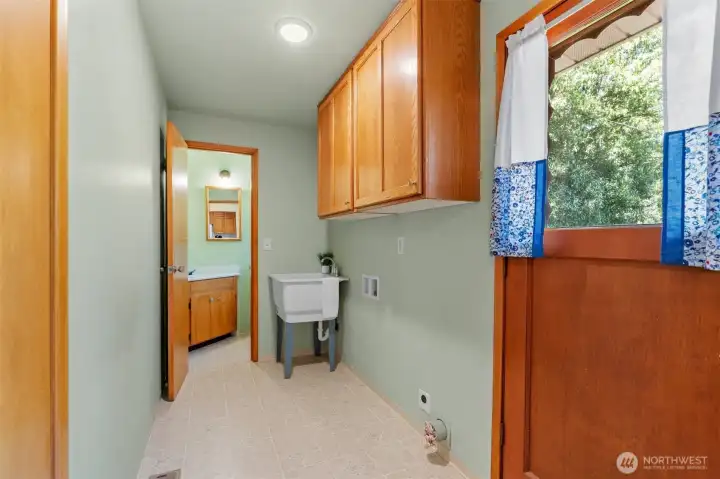 The laundry-mud room is perfect for rainy days, wet boots, and even has a mop sink.