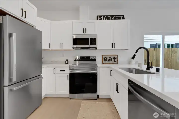 White Shaker Cabinets, Quartz Countertops and   SS Appliances.