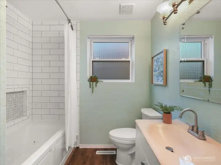 Full guest bath with classic subway tile surround and a bread basket tile cut out.