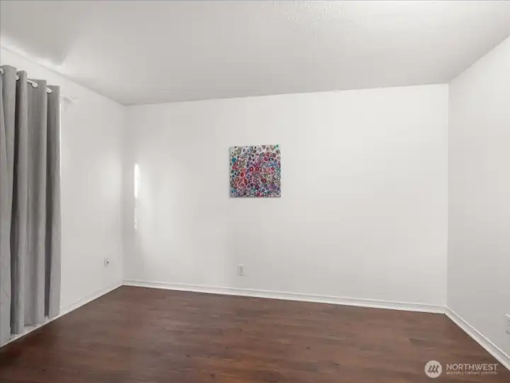 Generous bedroom with Hickory flooring.