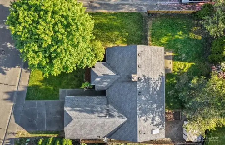Aerial photography highlights the fully fenced yard and outdoor living spaces.