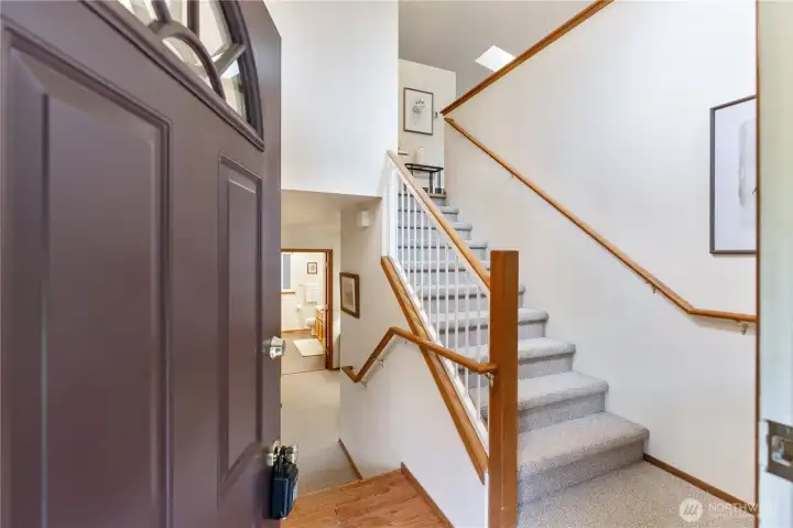 As you enter there are 2 landings upstairs to the main floor and down stairs to 2 bedrooms, office/den space, laundry & full bath
