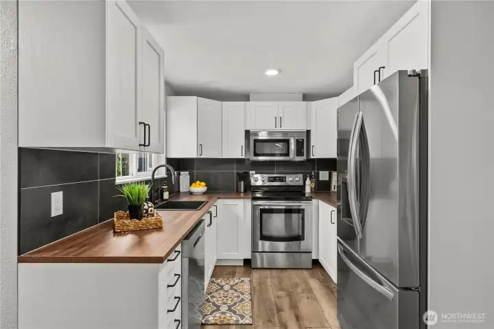 Fully remodeled kitchen with new white shaker cabinetry, stainless steel appliances, and new countertops. Fully remodeled kitchen with new white shaker cabinetry, stainless steel appliances, and new countertops.