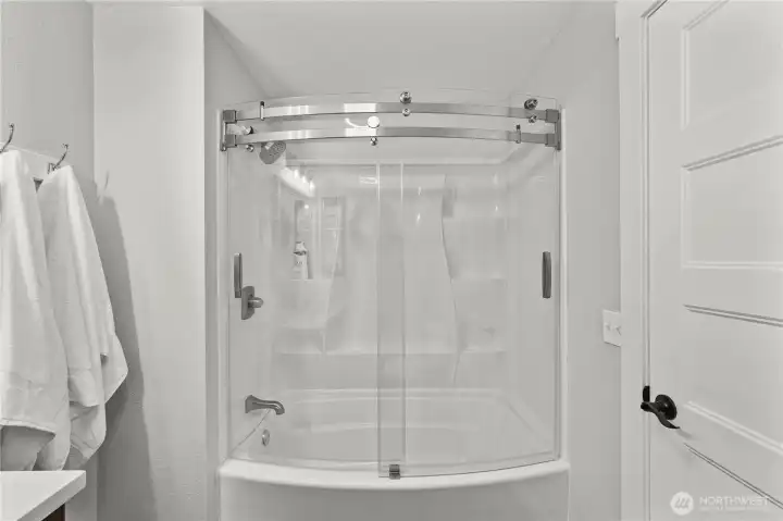 Full bath features tub/shower surround, contemporary fixtures, and modern designer finishes. Full bath features tub/shower surround, contemporary fixtures, and modern designer finishes.