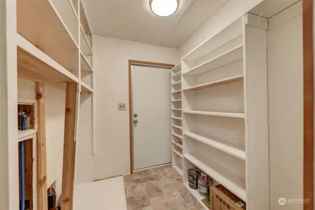 Large utility room with washer and dryer hookups, leading out to the back porch access.