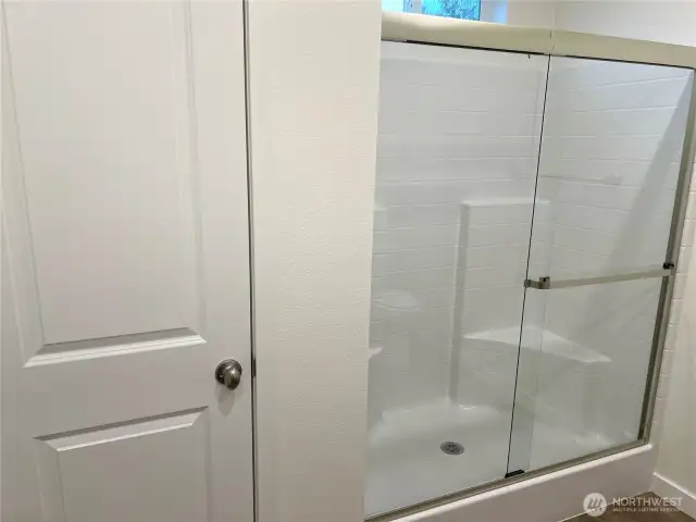 Primary shower and linen closet.