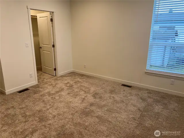 Primary bedroom looking at walk in closet.