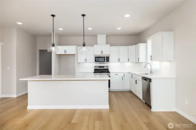 The kitchen has a nice size island and quartz countertops.