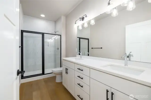 There is a tile shower and double sinks with a taller toilet in the primary bathroom.  Lots of counter space!