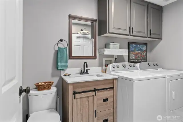 Lower-level half bath/utility room with large closet/pantry!