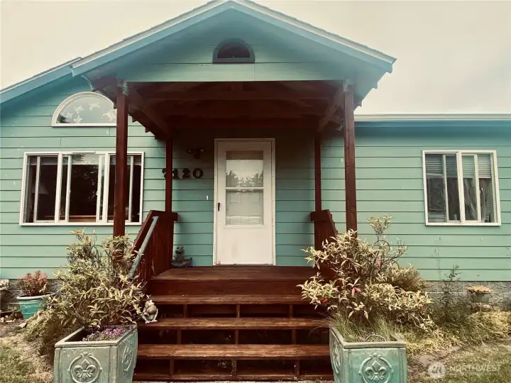 Covered porch with half circle drive and plenty of off St parking for boat or RV