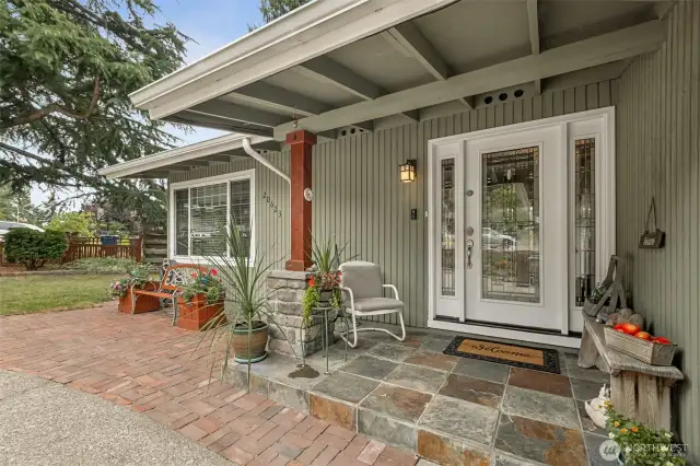 Welcoming covered porch with tiled entry and double-side-lite glass door!