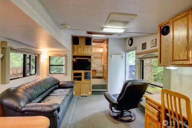 View of living space and into bathroom and bedroom