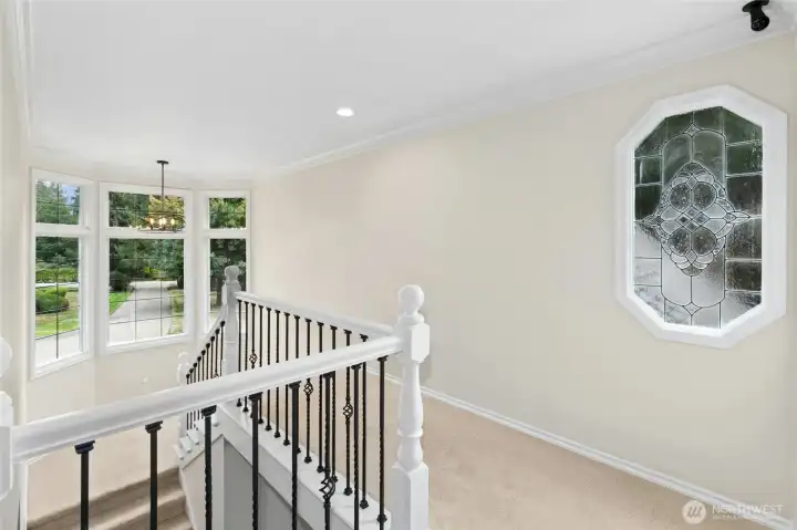 Wrought-iron staircase overlooks the beautiful front yard.
