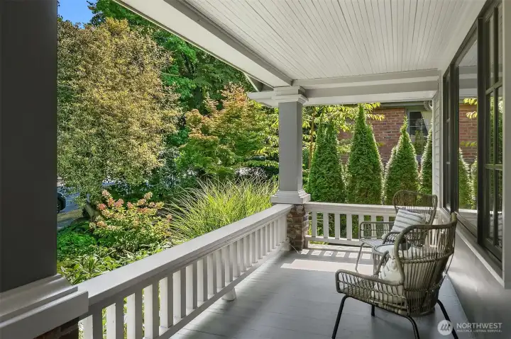 Covered front porch is calling for your relaxing cup of coffee.