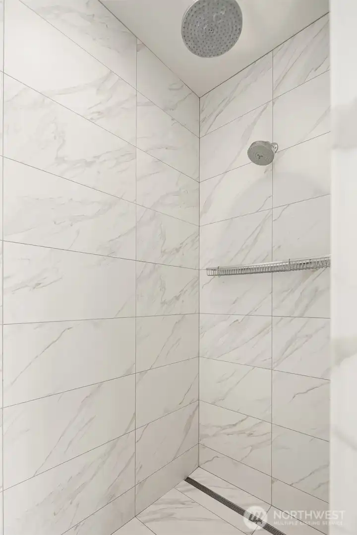 Large walk-in shower in primary bathroom.