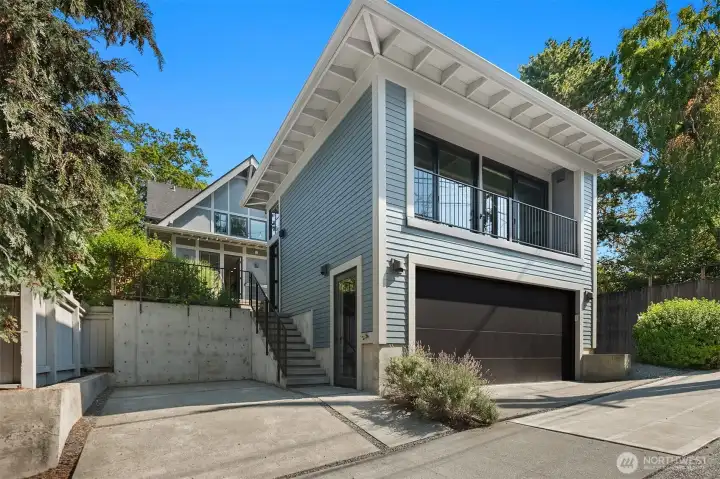 View from back street showing 2 car garage and additional off-street parking spot.